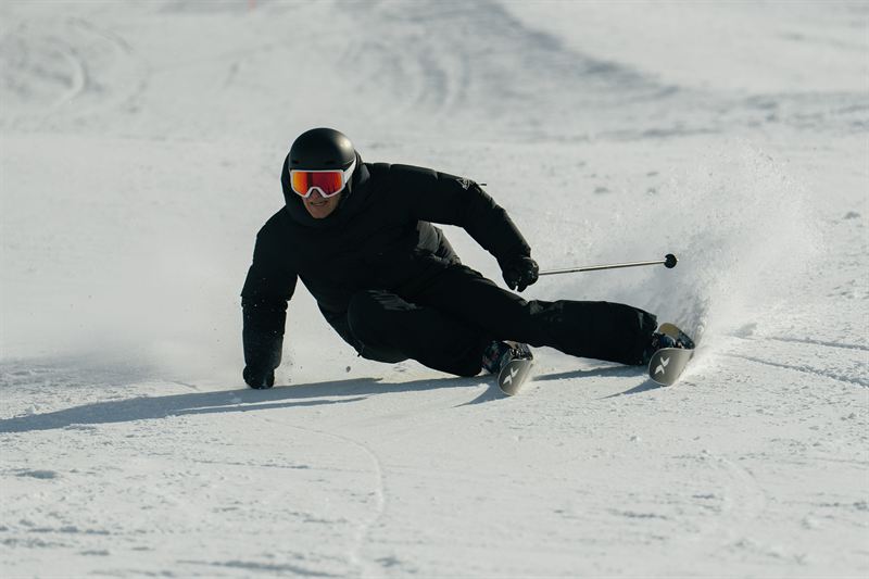 Skier carving a confident turn on piste