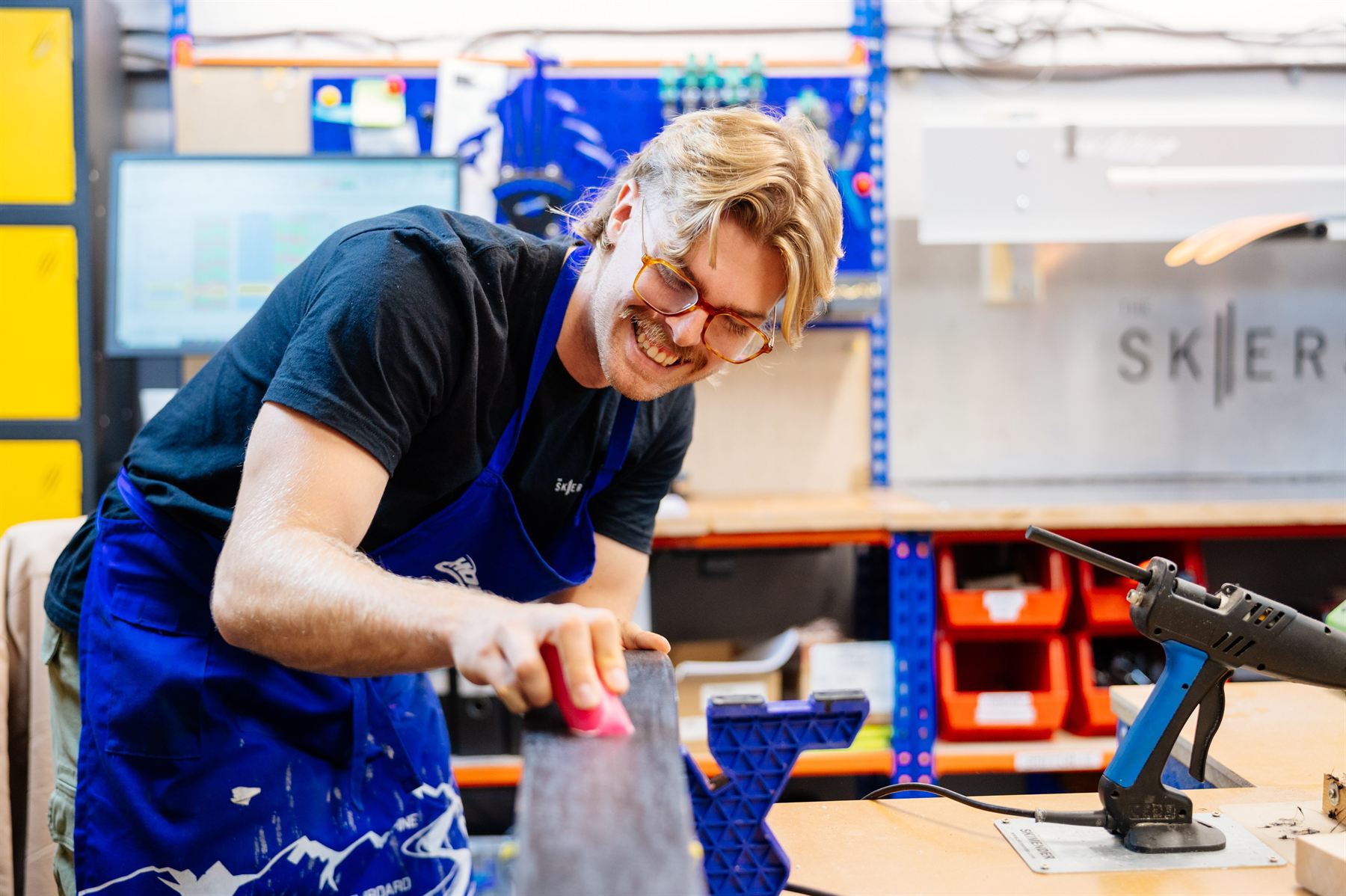 Louis servicing a ski in The Skiers Lounge workshop, Horsham